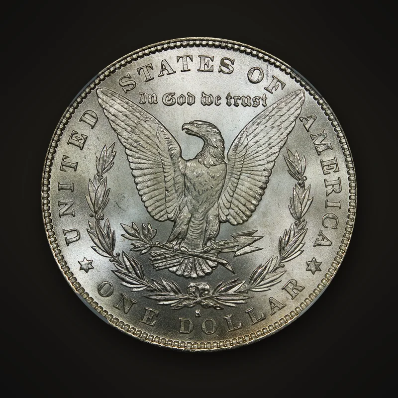 Dollar Morgan de 1879, revers : aigle aux ailes déployées dans une couronne de laurier, lettre d’atelier S